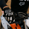 Motocross rijder met Fox Racing handschoenen op crossmotor – grip en stijl gecombineerd
